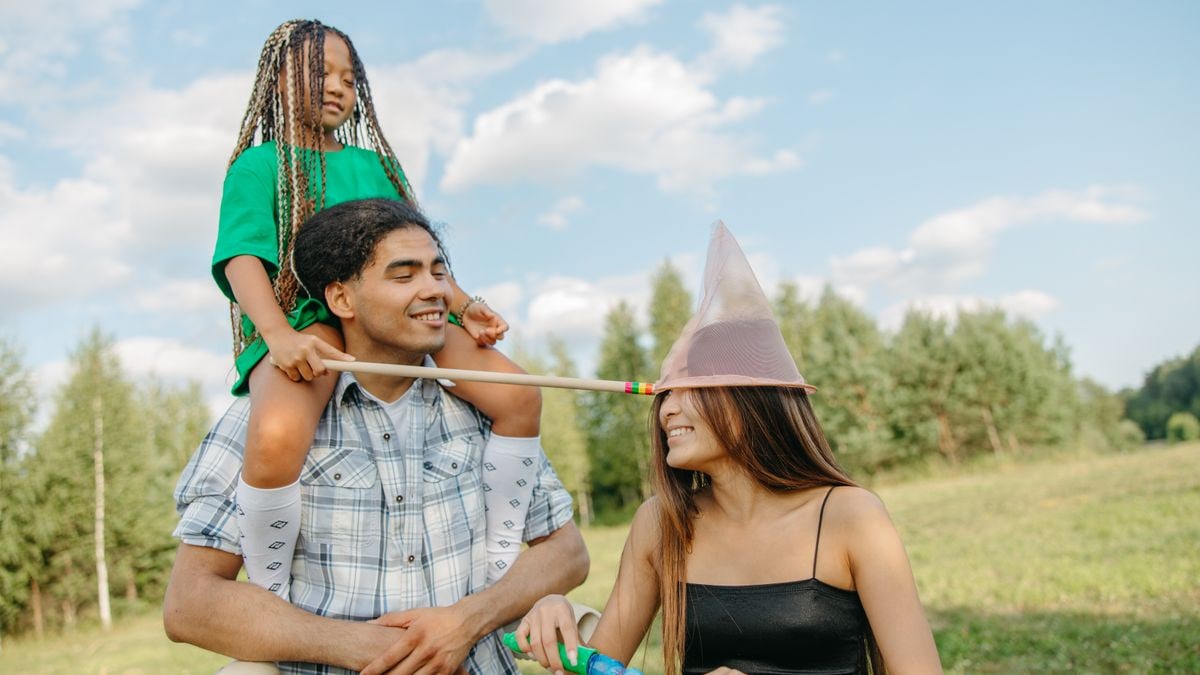 Joyful family enjoying quality time outdoors in summer with playful activities.
